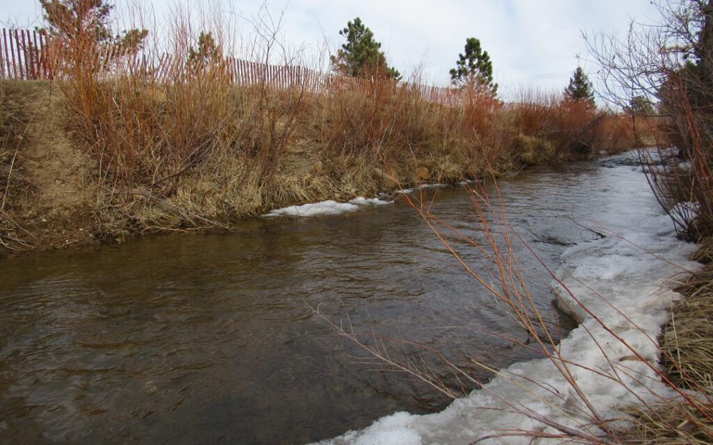 An irrigation ditch flows on the Marshall Mesa in Boulder County. A new USDA report shows little progress has been made in reducing overall ag water use in the state, despite millions of dollars spent on water-saving projects. Credit: Jerd Smith 