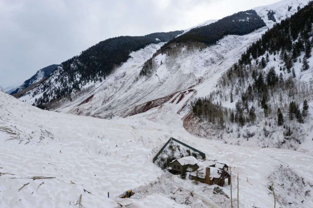 The avalanche that fractured across a nearly two-mile-wide section of Highlands Ridge in March 2019 was one of the largest in Colorado history. A home in its path survived with minimal damage thanks to a defensive wedge above it. Courtesy of Brandon Huttenlocher/CAIC