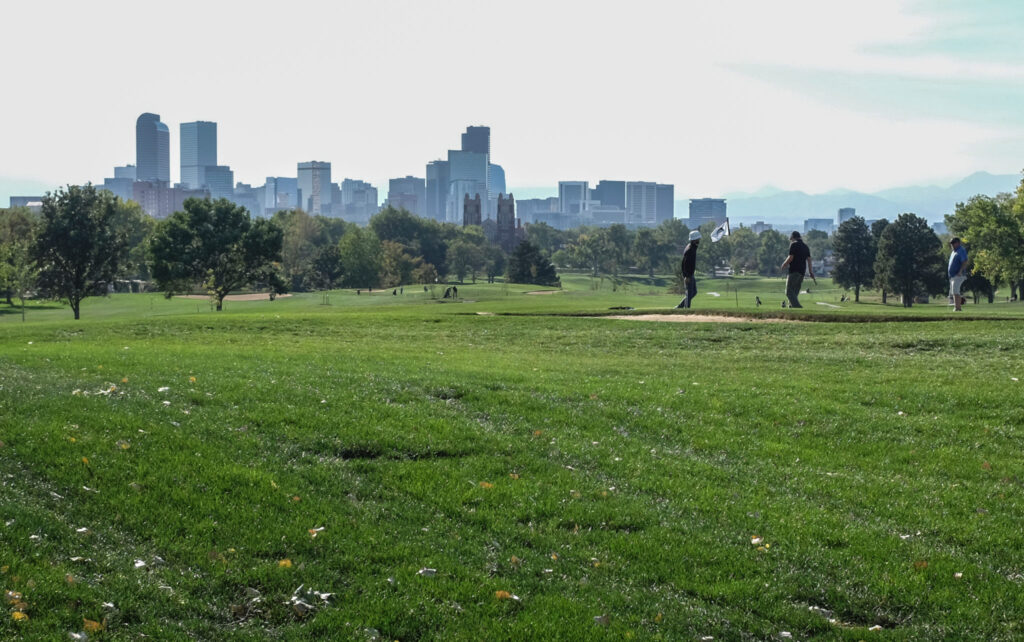 Golfers take shots on the green lawns of the City Park Golf Course in central Denver on Sept. 28 2020