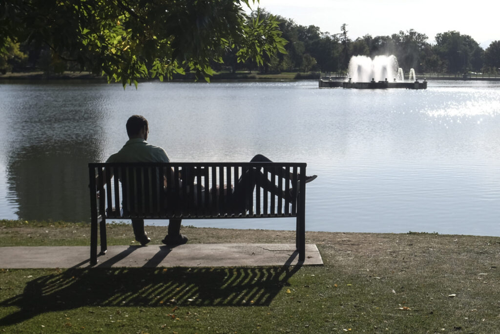 A couple sits at the edge of the lake at City Park in central Denver on Sept. 28 2020. In a typical year, about 48 percent of Denver’s water comes from the Western Slope. 