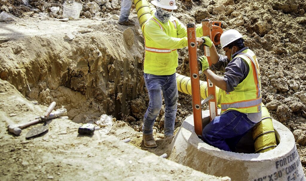 Contractors for Houston Public Works work on a wastewater and drainage project in the Greater Eastwood neighborhood. Pipe repairs and water infrastructure upgrades, which also contribute jobs to a local economy, could be a point of bipartisan compromise. Photo © Elizabeth Conley / Circle of Blue