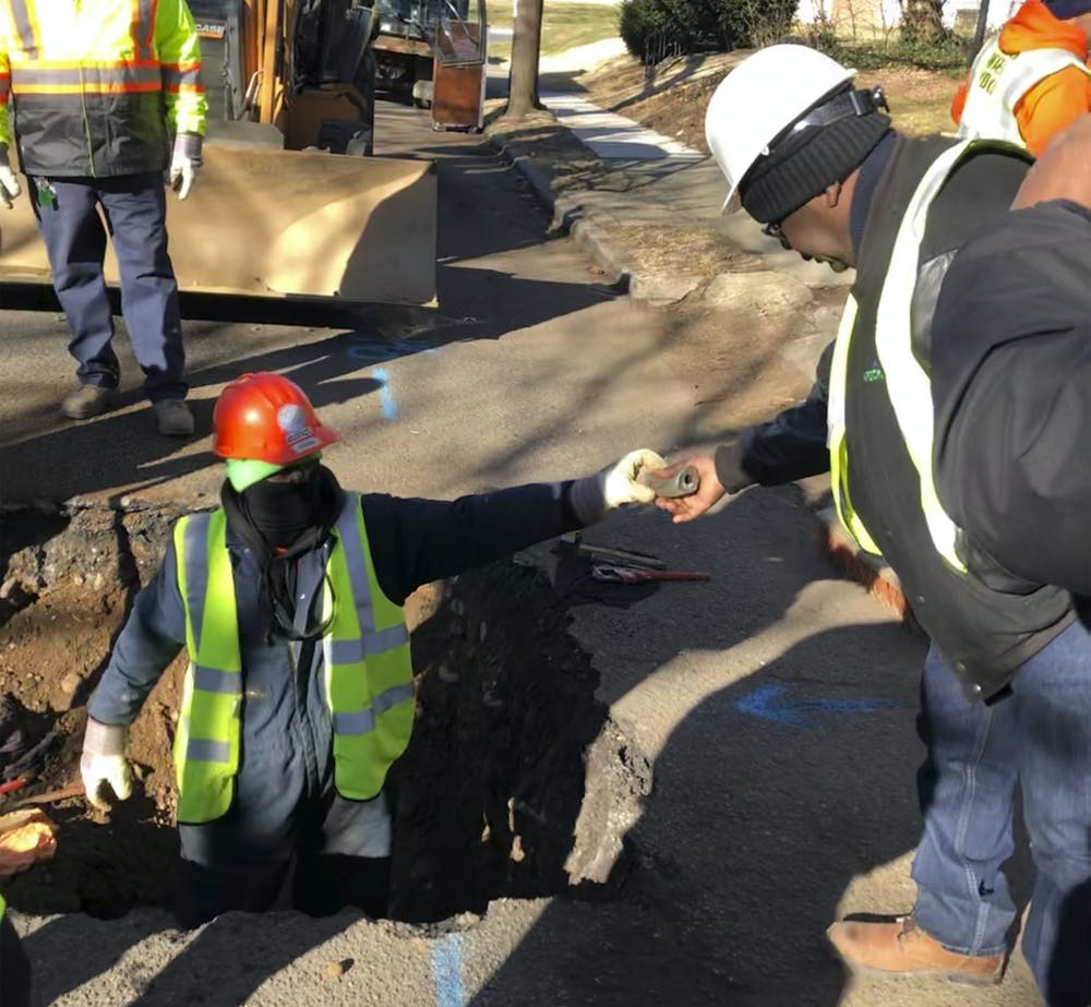 Workers removing water service lines