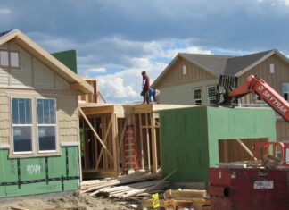 Construction workers build a single family home in Castle Rock photo