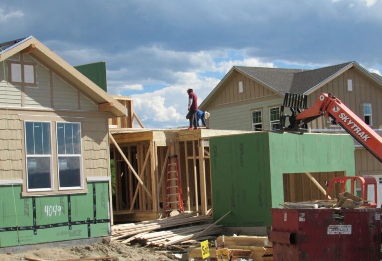 Construction workers build a single family home in Castle Rock photo