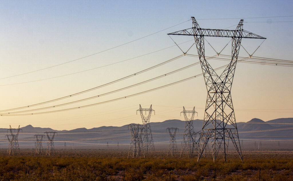 Transmission lines march outward from Hoover Dam, delivering the dam's hydroelectric power to cities, irrigation districts, and tribes across the Southwest.
