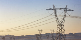 Transmission lines march outward from Hoover Dam, delivering the dam's hydroelectric power to cities, irrigation districts, and tribes across the Southwest.