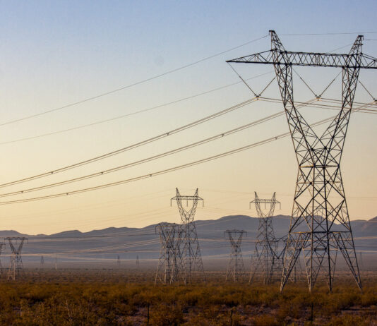 Transmission lines march outward from Hoover Dam, delivering the dam's hydroelectric power to cities, irrigation districts, and tribes across the Southwest.