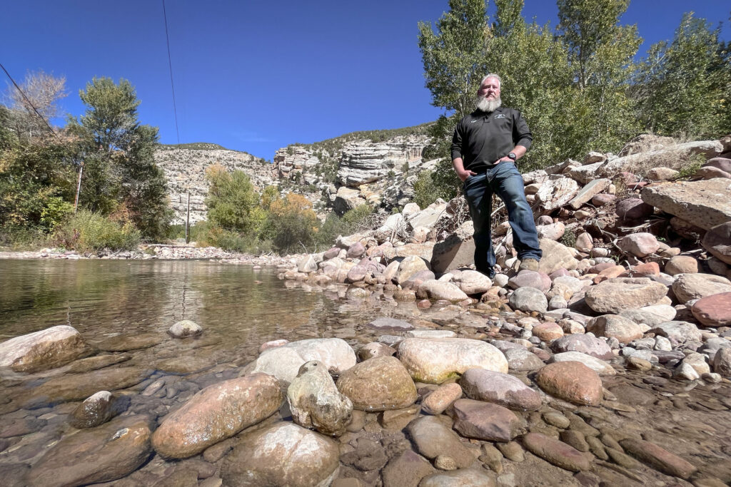 Ryan Goodrich of the Ashley Valley water district stands next to Ashley Creek, Oct. 2, 2025. This tributary of the Green River provides water for communities around Vernal, but it has run low this year because of drought.