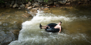 Tubers enjoying Boulder Creek flowing through Eben Fine Park, Boulder CO.