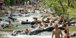 Tubers enjoying Boulder Creek flowing through Eben Fine Park, Boulder CO.