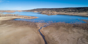 Lyman Lake, AZ, stores water from the Little Colorado River near its headwaters for use by downstream farmers and the Zuni Tribe. In 2021, the lake is 30 ft. below full. The Little Colorado enters the lake as a tiny stream.